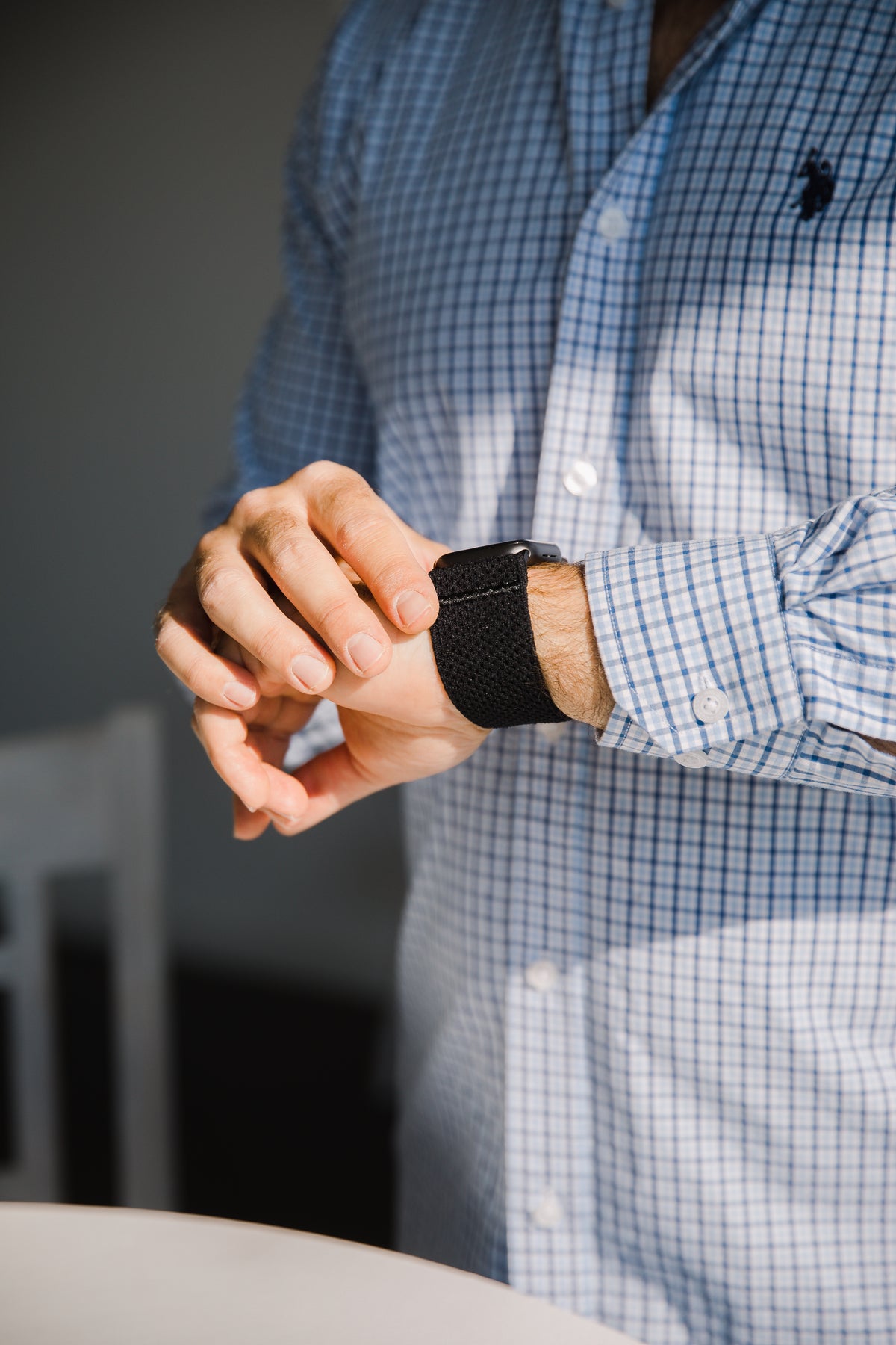 Torso of a person checking their watch